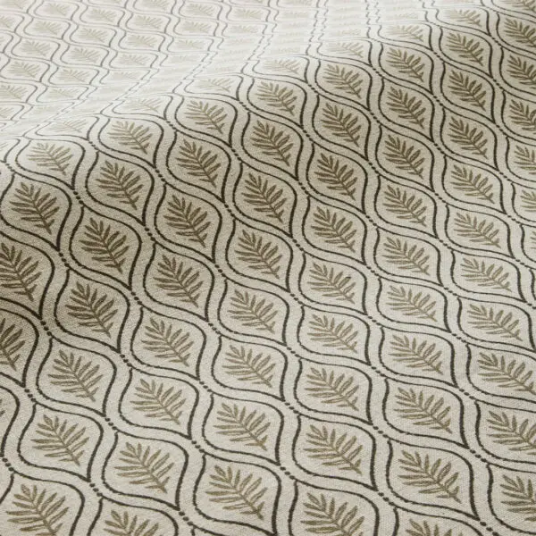Soft, muted, earthy coloured fabric that is hand-printed showcasing fallen leaves