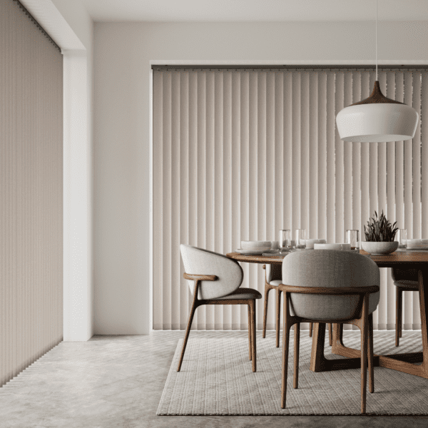 Dinning room with table and chairs and large windows with vertical blinds in the background, all in neutral tones.