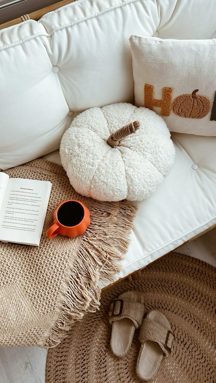 Halloween decor layed over a couch with a cup of coffee